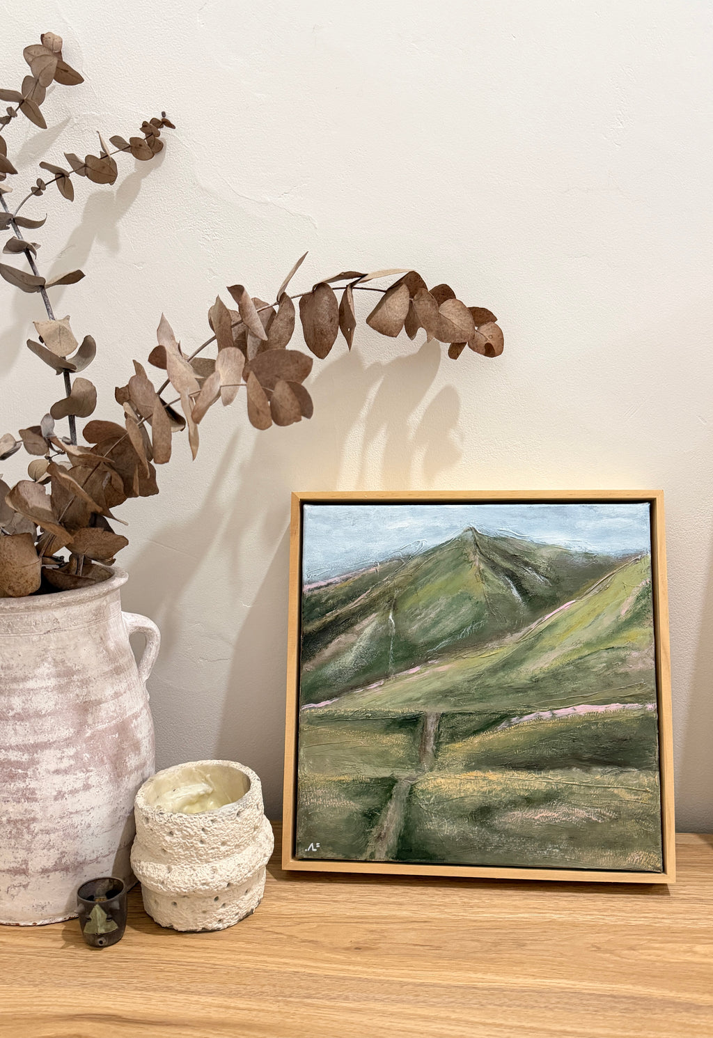 Shark Tooth mountain art print styled on a timber shelf with dried eucalyptus and ceramics.